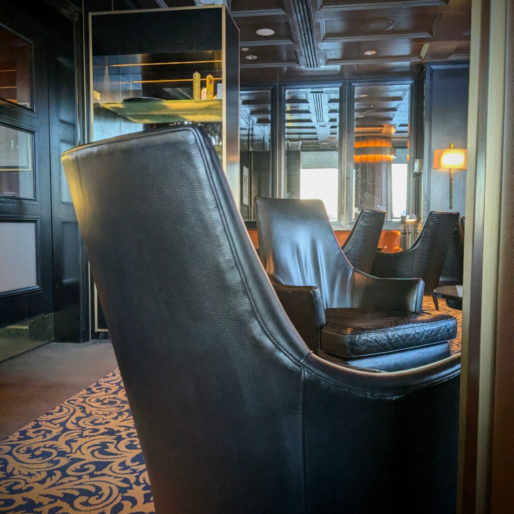 Smoke Show: Sipping Fine Spirits at Bar Bacchus Cigar Lounge black wingback chair at bacchus cigar lounge gatineau